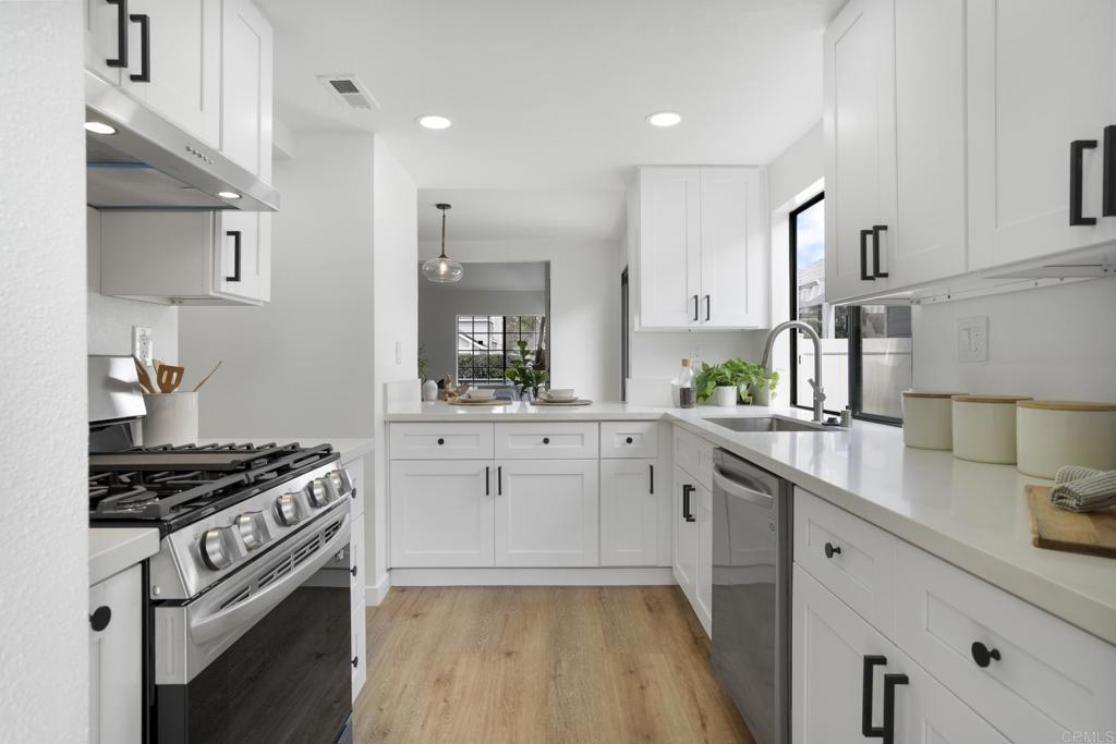 803 Skysail Avenue Carlsbad, CA 92011 - Photo 7 of 15 a kitchen with white cabinets and appliances