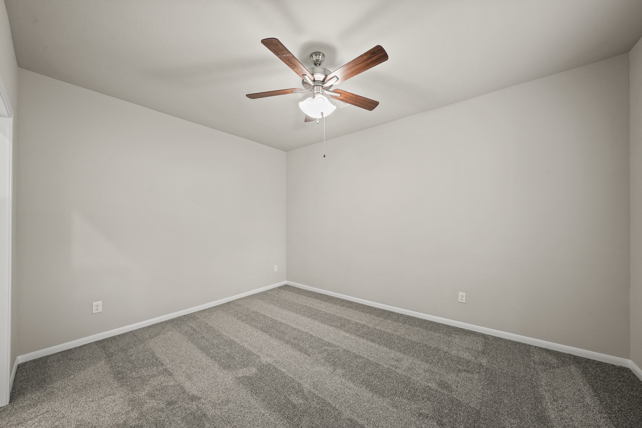 15025 Alkay Street Houston, TX 77053 - Photo 5 of 11 an empty room with window and ceiling fan