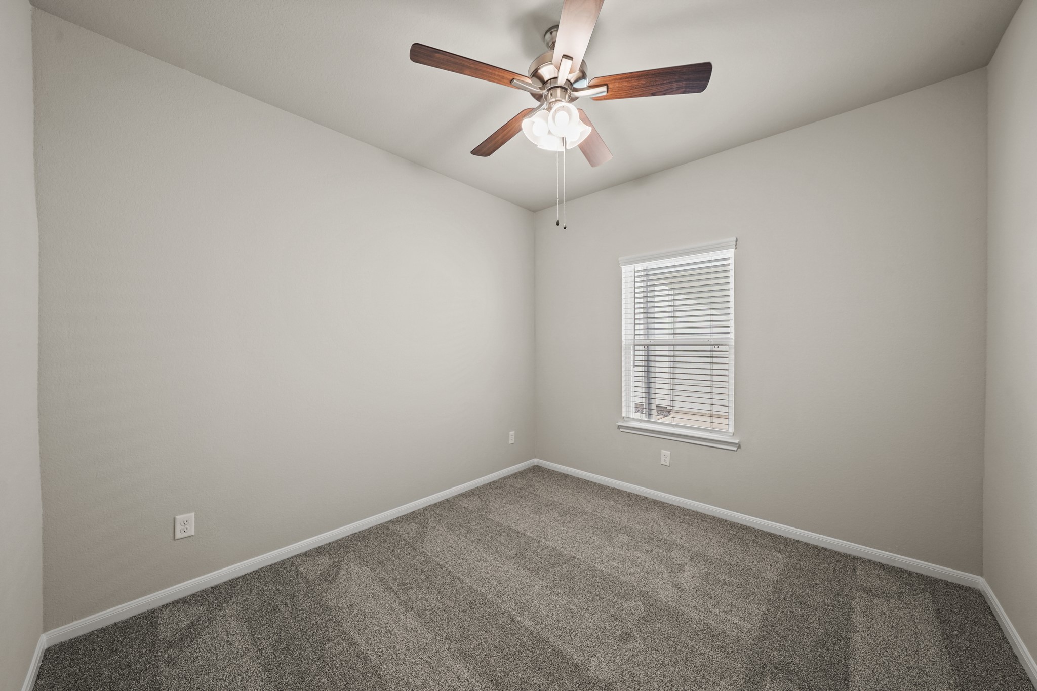 15025 Alkay Street Houston, TX 77053 - Photo 9 of 11 an empty room with a window and a fan