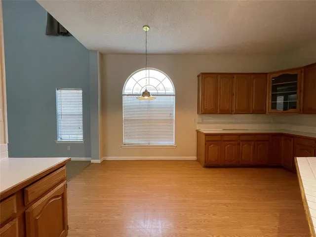 a kitchen with a sink cabinets and window