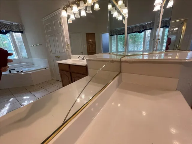a en suite bathroom with a double vanity sink and a large mirror