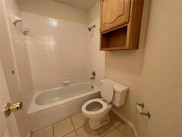 a bathroom with a toilet a sink and bathtub