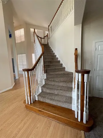 a view of entryway and hall with wooden floor