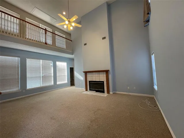 a view of an empty room with a fireplace and a window