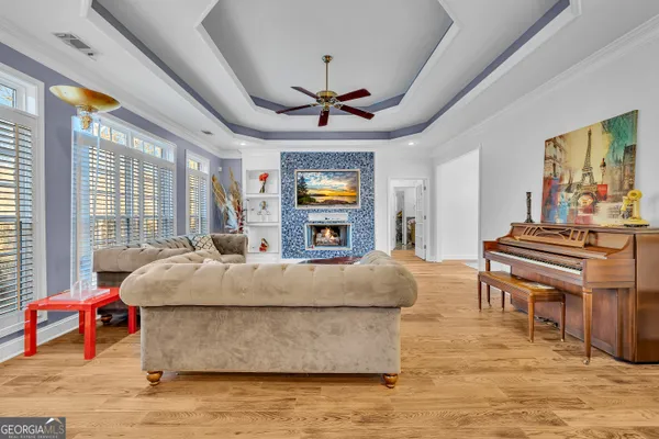 a living room with stainless steel appliances granite countertop furniture and a fireplace
