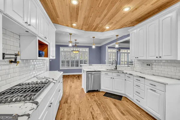 a kitchen with sink stove and cabinets