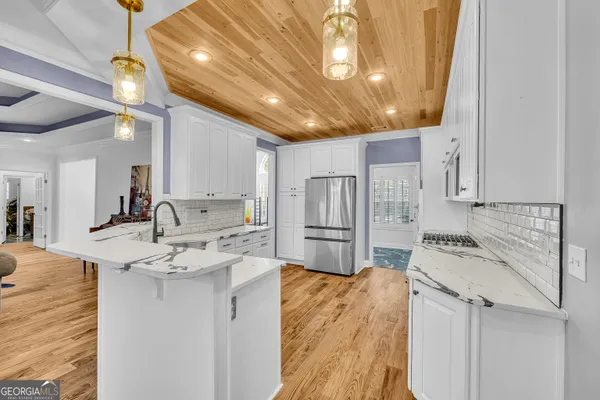 a kitchen with a sink appliances and cabinets