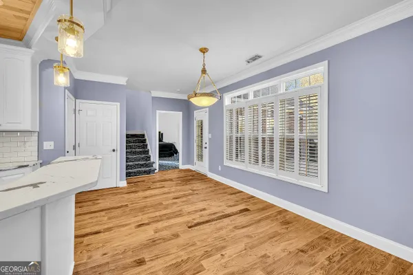 a bedroom with a bed mirror and a window