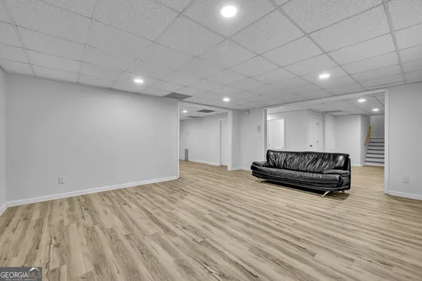 a view of a room with wooden floor