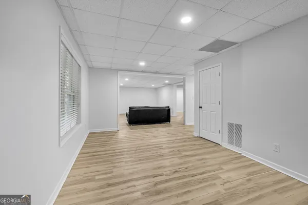 a view of empty room with wooden floor