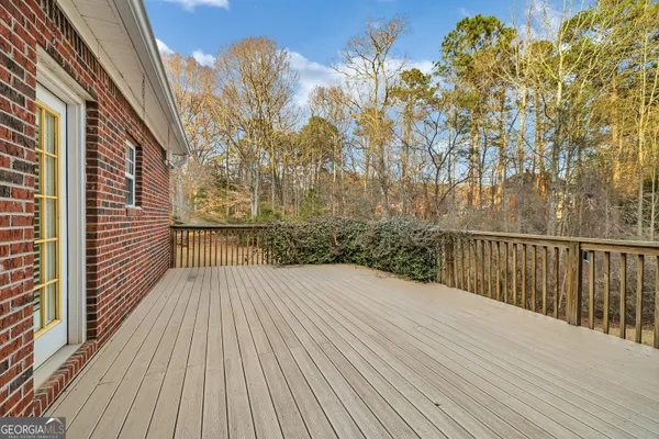 a view of a balcony with wooden floor and fence