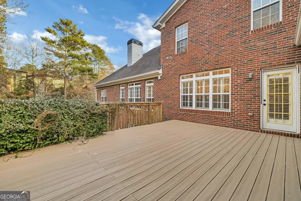 a view of backyard with a deck and wooden floor