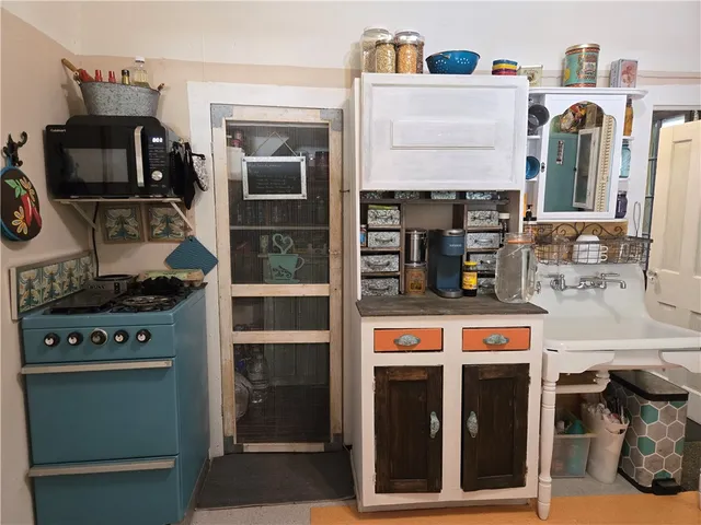 a bathroom with a sink a mirror and next to a window
