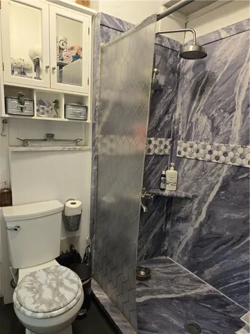 a living room with couches and pool table with wooden floor