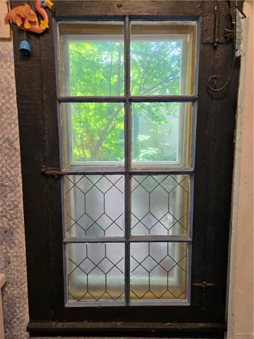 a view of a room with wooden floor and furniture