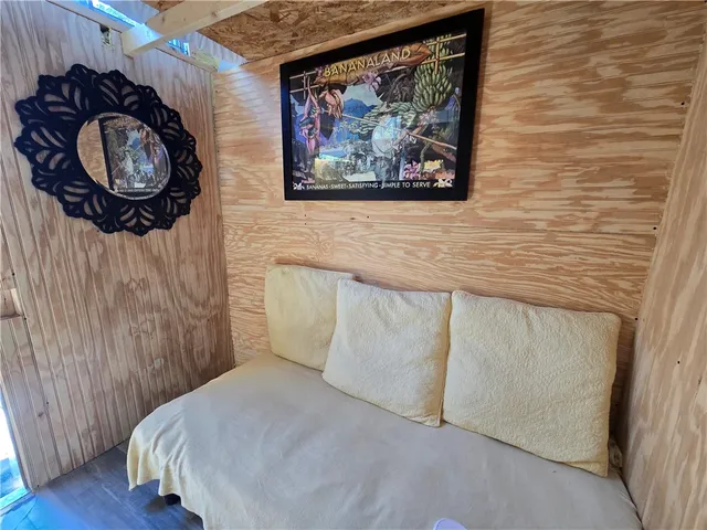 a living room with patio furniture and garden view