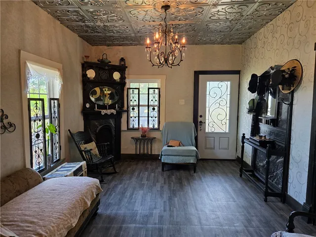 a living room with furniture and a chandelier