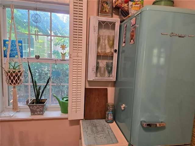 a kitchen with stainless steel appliances granite countertop a refrigerator and a stove