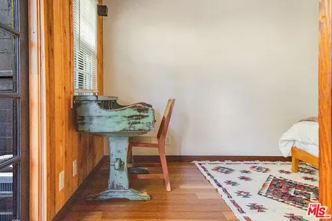 a view of a balcony with a yard