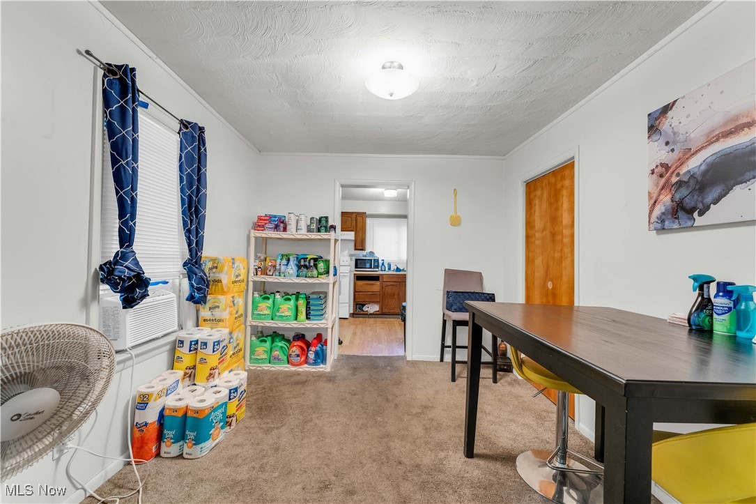 4149 Bluestone Road Cleveland, OH 44121 - Photo 35 of 41 Recreation room with cooling unit, crown molding, carpet flooring, and a textured ceiling