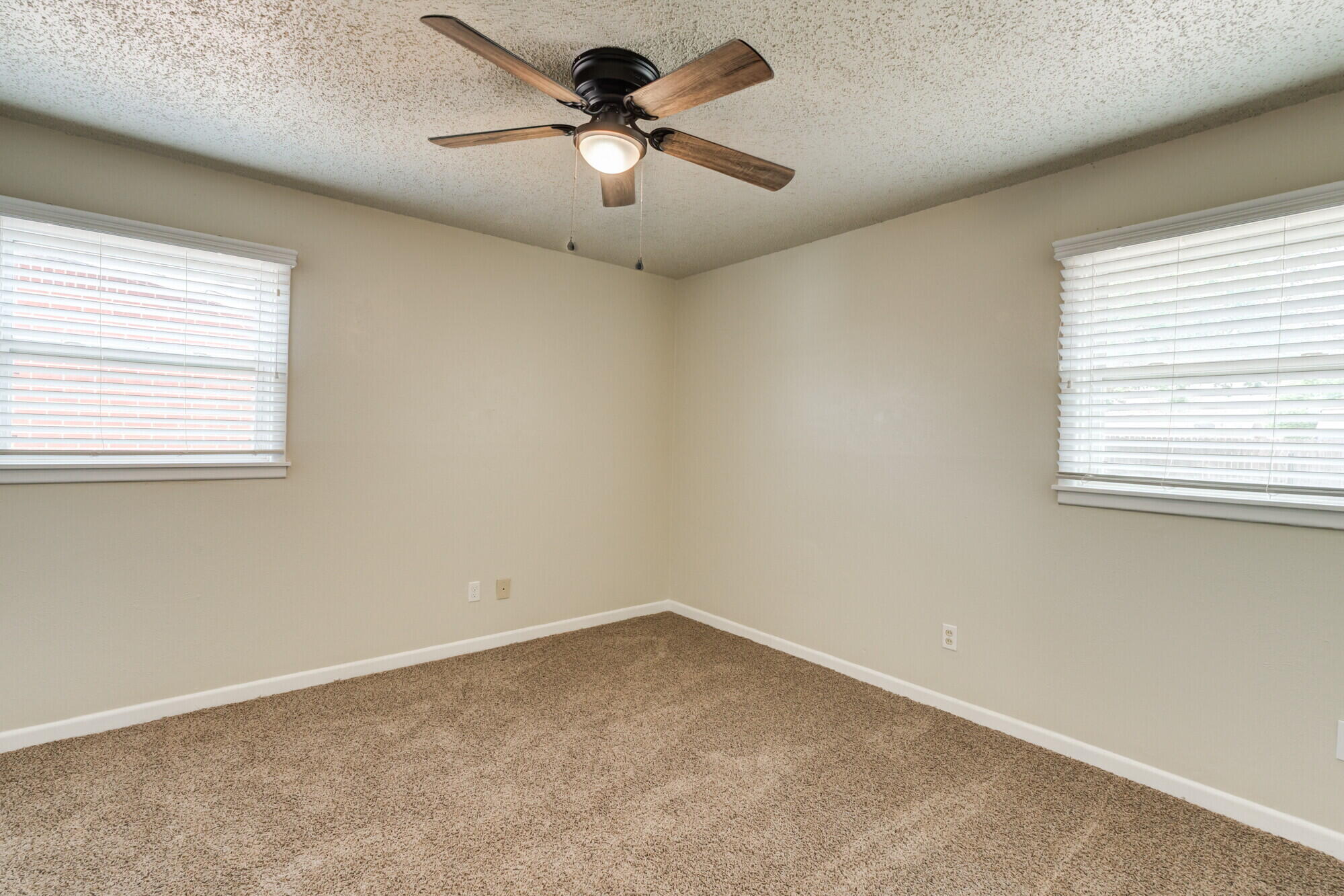 5017 46th Street Lubbock, TX 79414 - Photo 18 of 32 an empty room with a window and a fan