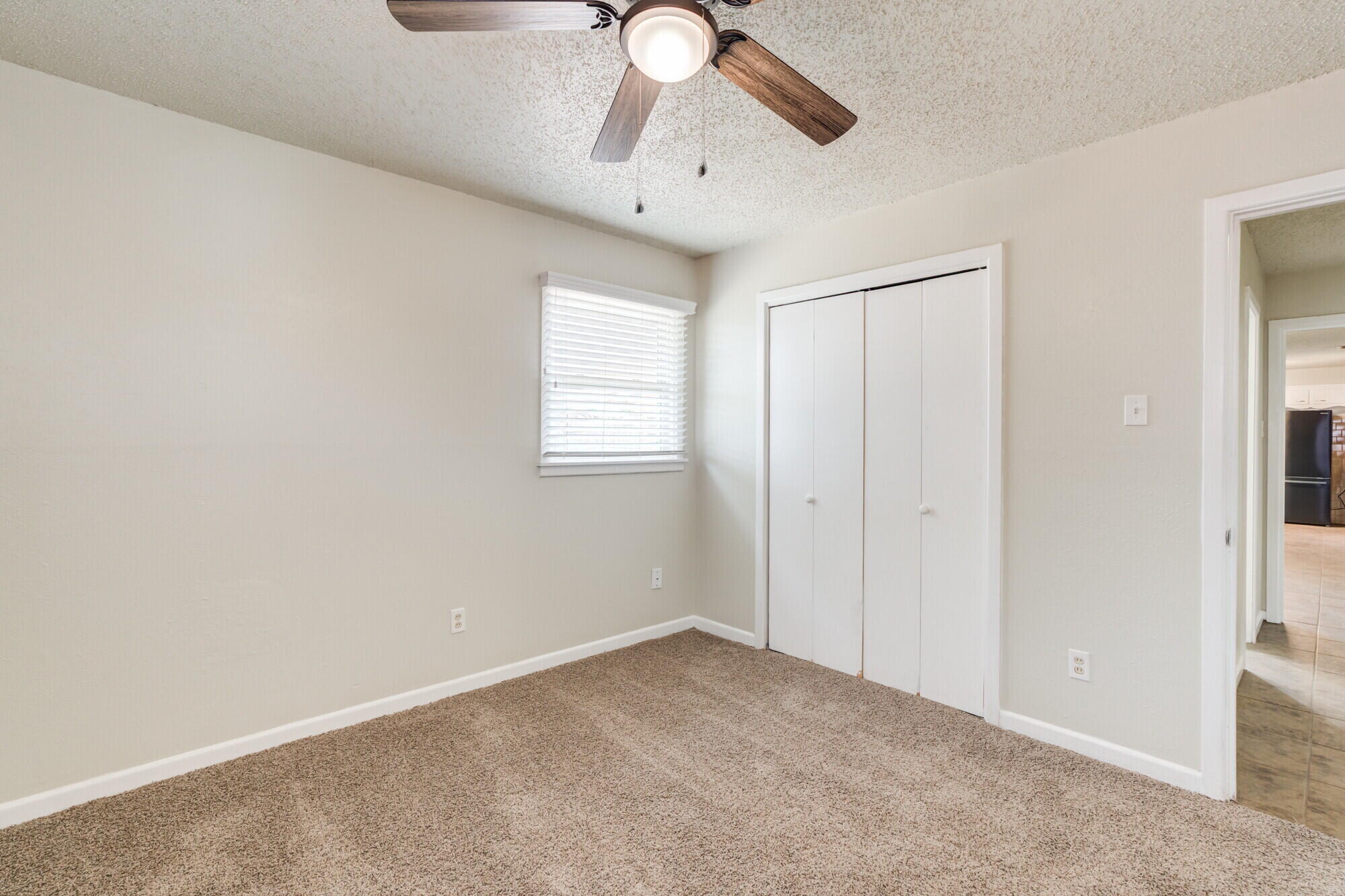 5017 46th Street Lubbock, TX 79414 - Photo 19 of 32 a view of an empty room with window and chandelier fan