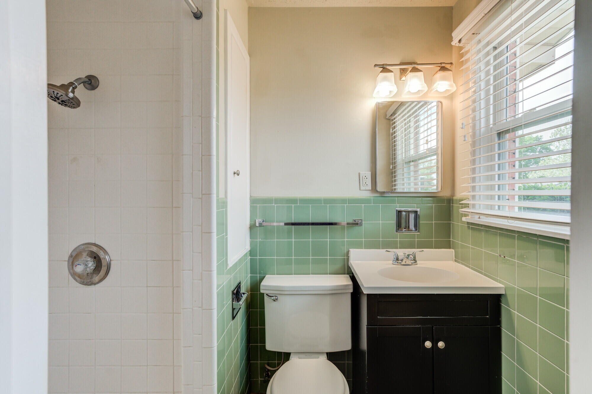 5017 46th Street Lubbock, TX 79414 - Photo 28 of 32 a bathroom with a sink mirror toilet and next to a window