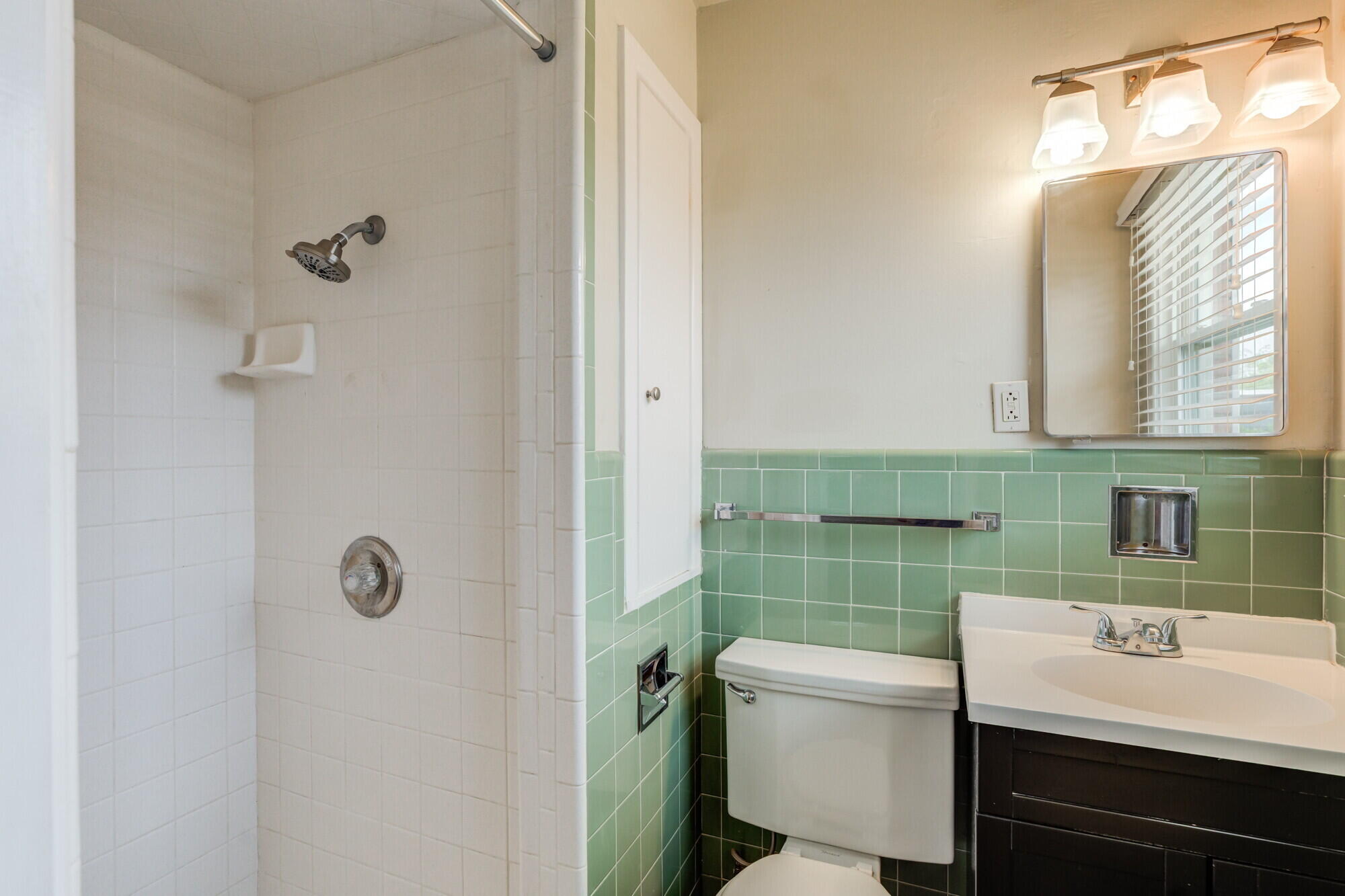 5017 46th Street Lubbock, TX 79414 - Photo 29 of 32 a bathroom with a sink toilet and mirror