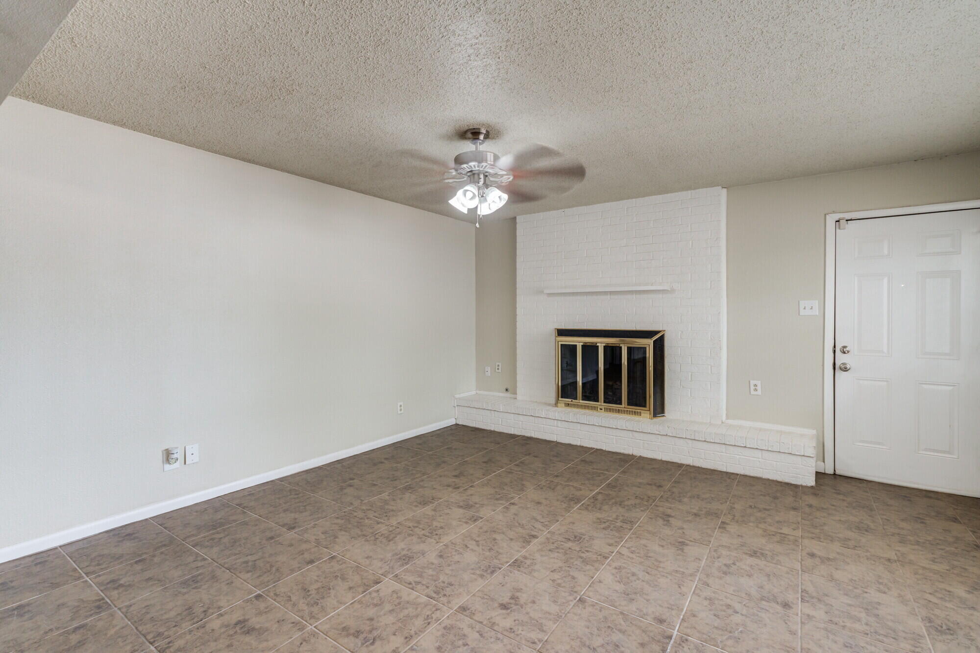 5017 46th Street Lubbock, TX 79414 - Photo 4 of 32 a view of an empty room with a ceiling fan and window