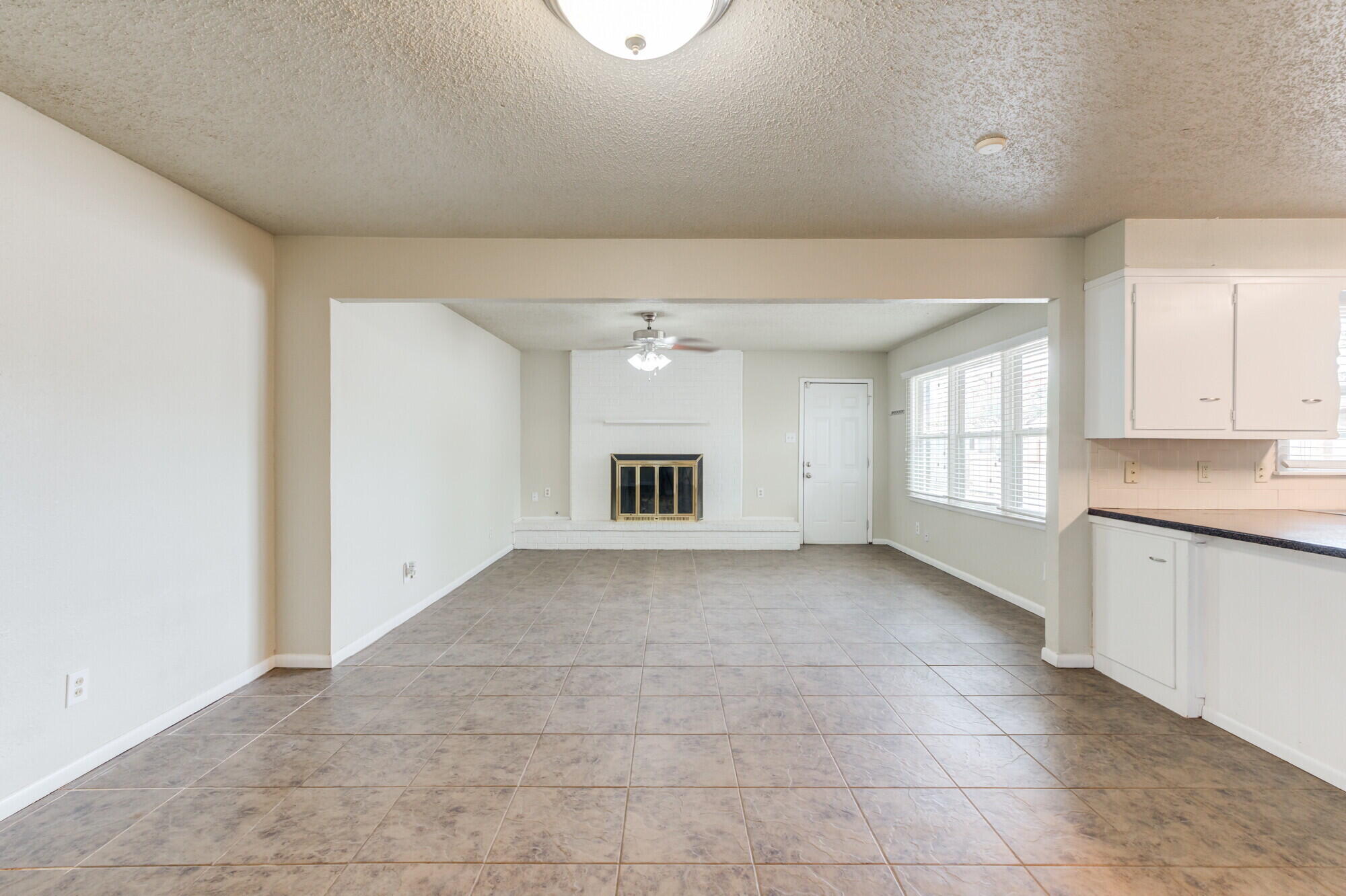 5017 46th Street Lubbock, TX 79414 - Photo 7 of 32 a view of an empty room with window and cabinet