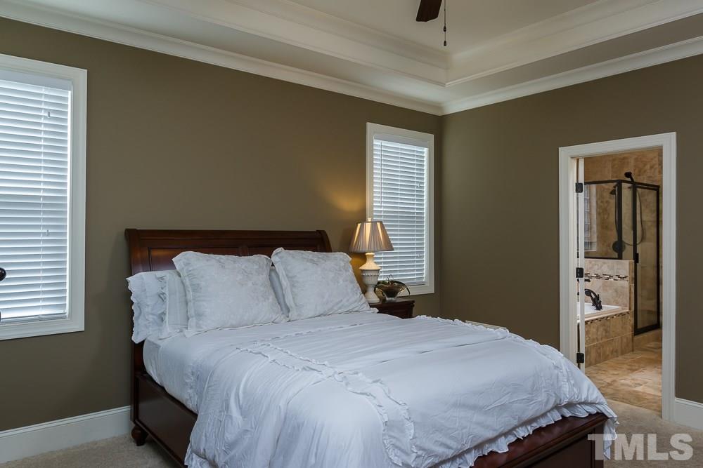 3429 Griffice Mill Road Raleigh, NC 27610 - Photo 12 of 25 a bedroom with a bed and wooden floor