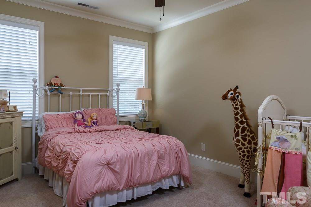 3429 Griffice Mill Road Raleigh, NC 27610 - Photo 15 of 25 a bedroom with a bed and a window