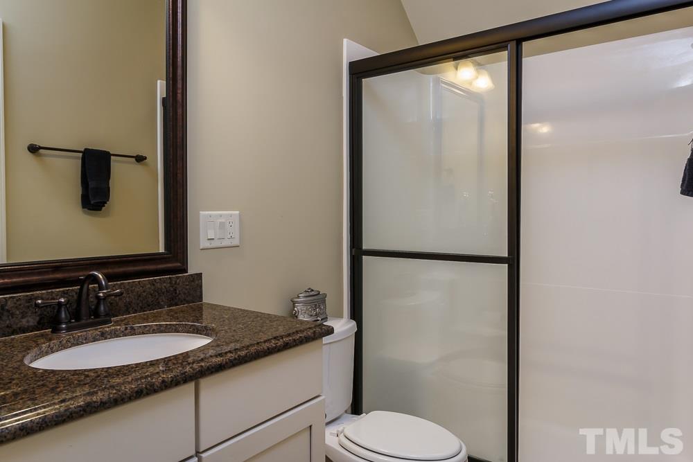 3429 Griffice Mill Road Raleigh, NC 27610 - Photo 17 of 25 a bathroom with a granite countertop sink toilet and mirror