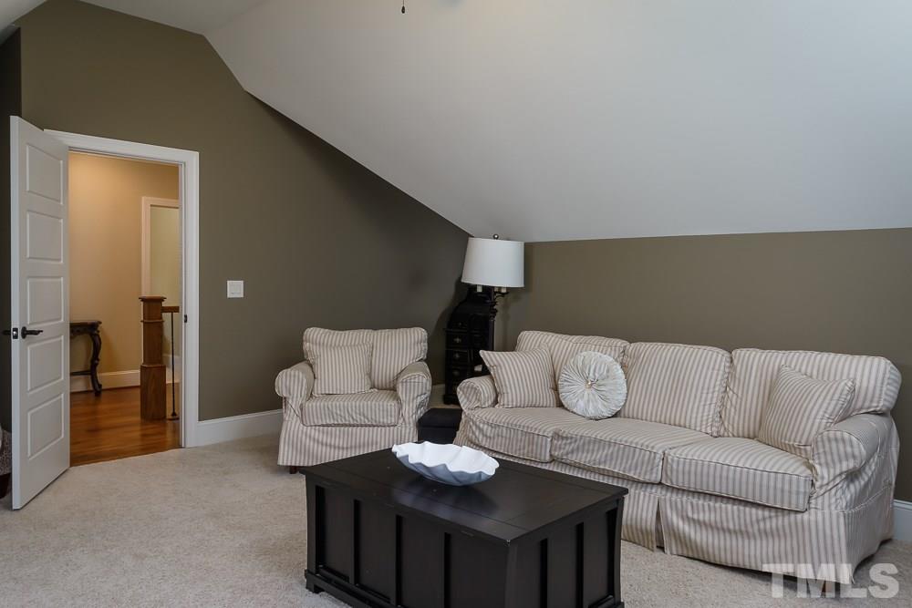 3429 Griffice Mill Road Raleigh, NC 27610 - Photo 20 of 25 a living room with furniture and a wooden floor