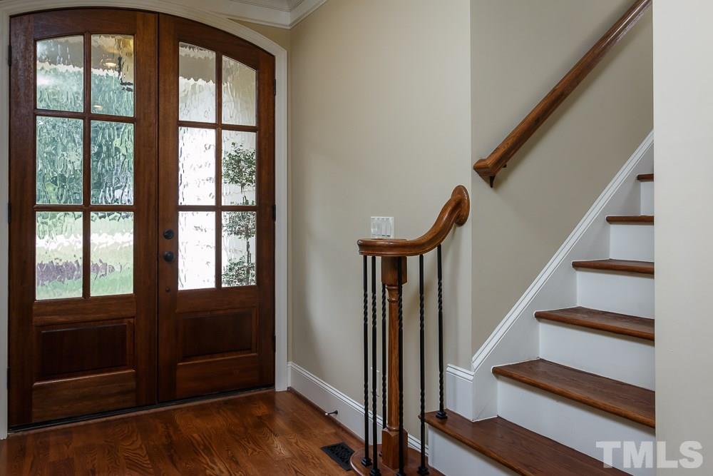 3429 Griffice Mill Road Raleigh, NC 27610 - Photo 3 of 25 a view of front door with wooden floor and stairs