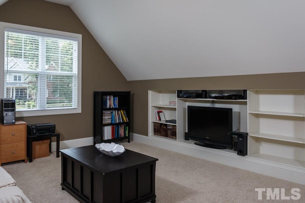 3429 Griffice Mill Road Raleigh, NC 27610 - Photo 21 of 25 a living room with furniture a flat screen tv and a fireplace