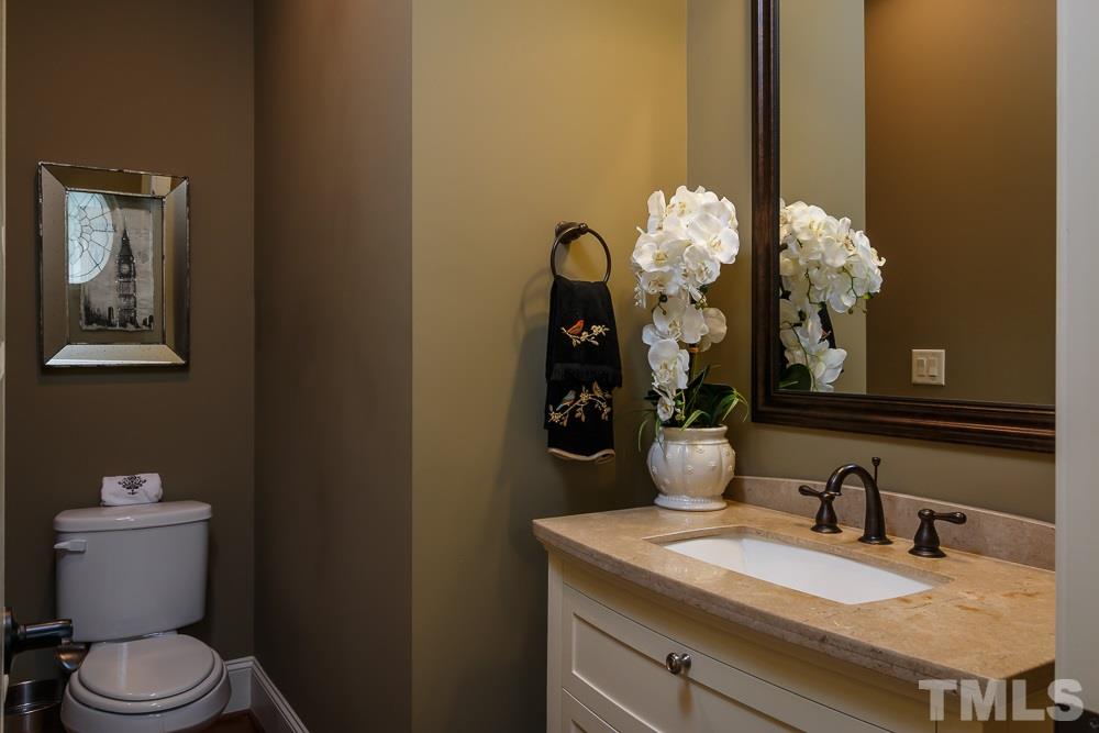 3429 Griffice Mill Road Raleigh, NC 27610 - Photo 5 of 25 a bathroom with a granite countertop sink a toilet and a mirror