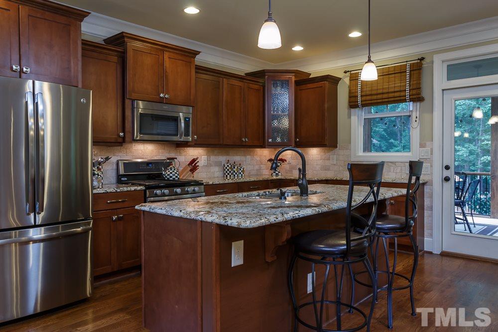 3429 Griffice Mill Road Raleigh, NC 27610 - Photo 9 of 25 a kitchen with stainless steel appliances granite countertop a stove a refrigerator and a microwave