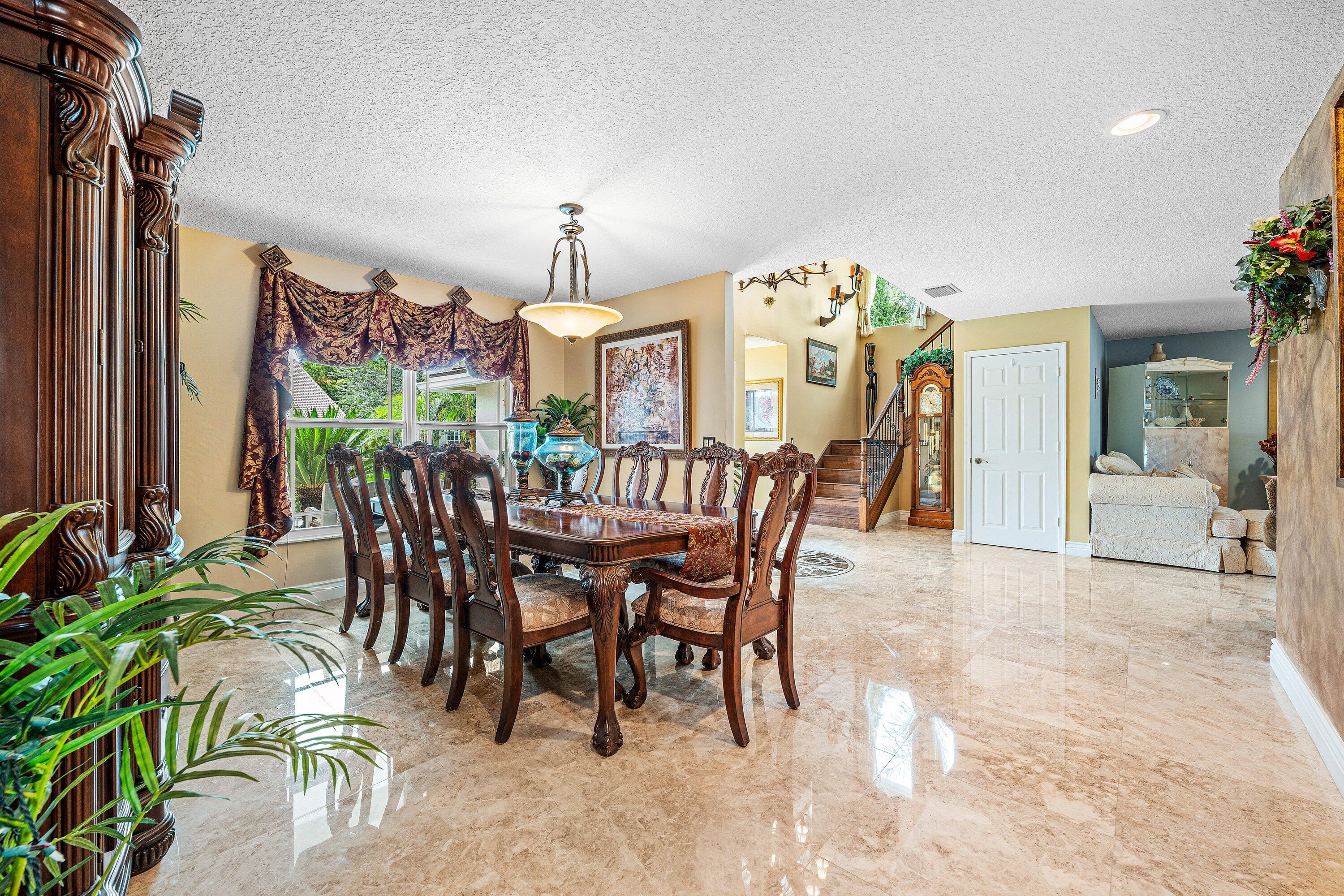 1548 Southwest 5th Avenue Boca Raton, FL 33432 - Photo 14 of 64 a view of a dining room with furniture and chandelier