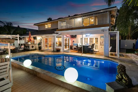a swimming pool view with a outdoor seating