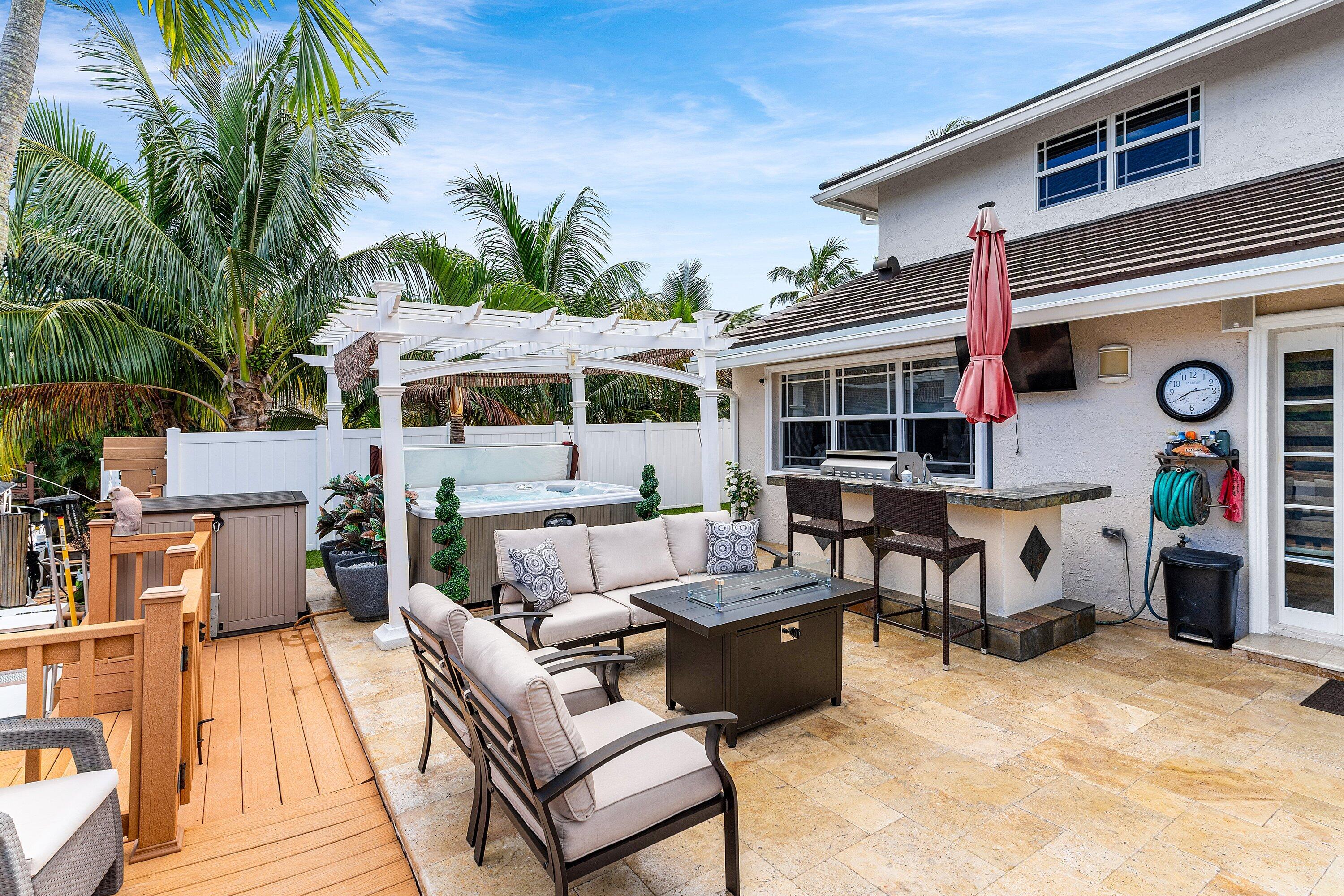 1548 Southwest 5th Avenue Boca Raton, FL 33432 - Photo 28 of 64 a view of a dinning table and chairs in patio of the house