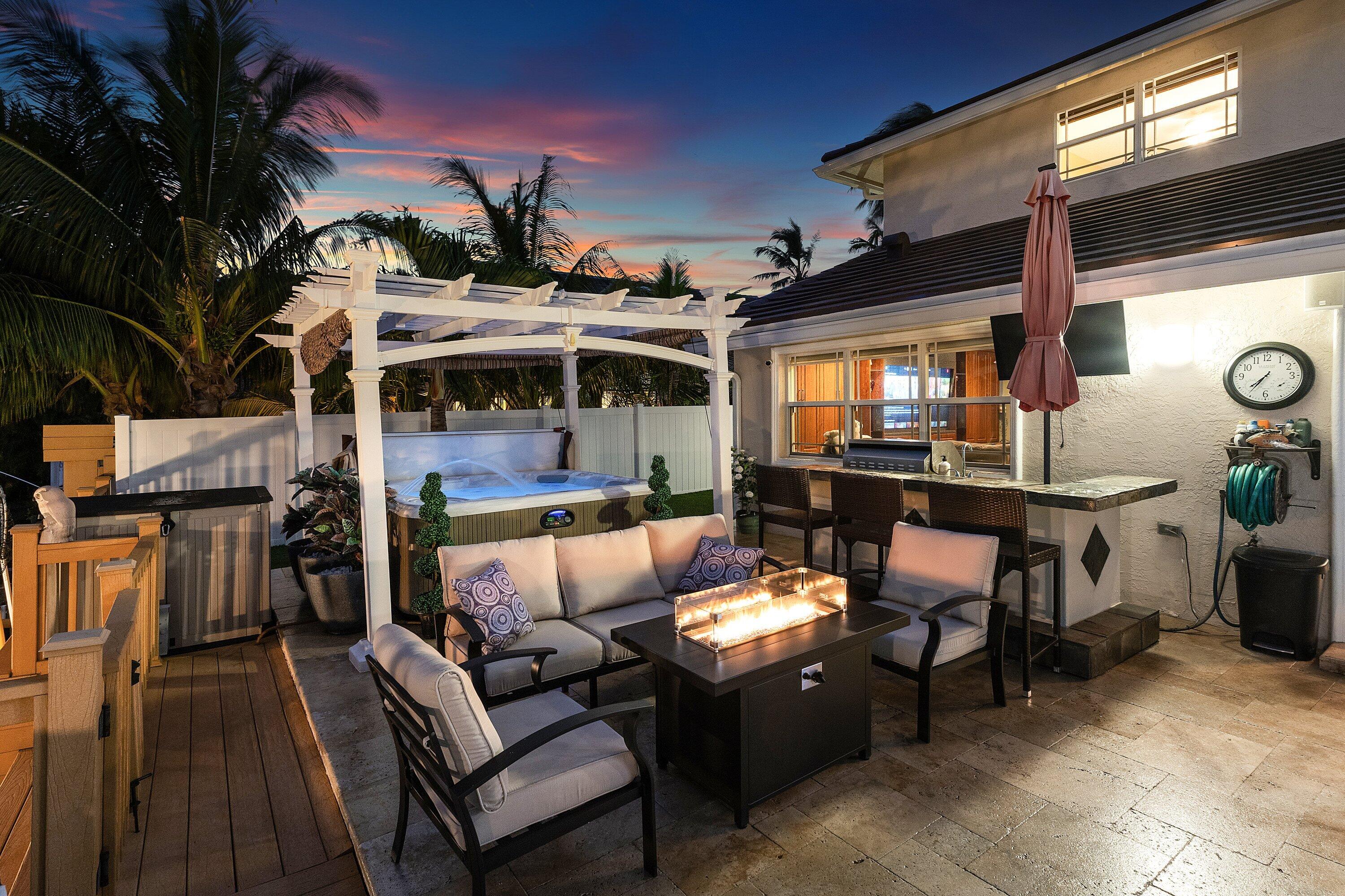 1548 Southwest 5th Avenue Boca Raton, FL 33432 - Photo 29 of 64 a view of a patio with dining table and chairs with a barbeque grill and couches