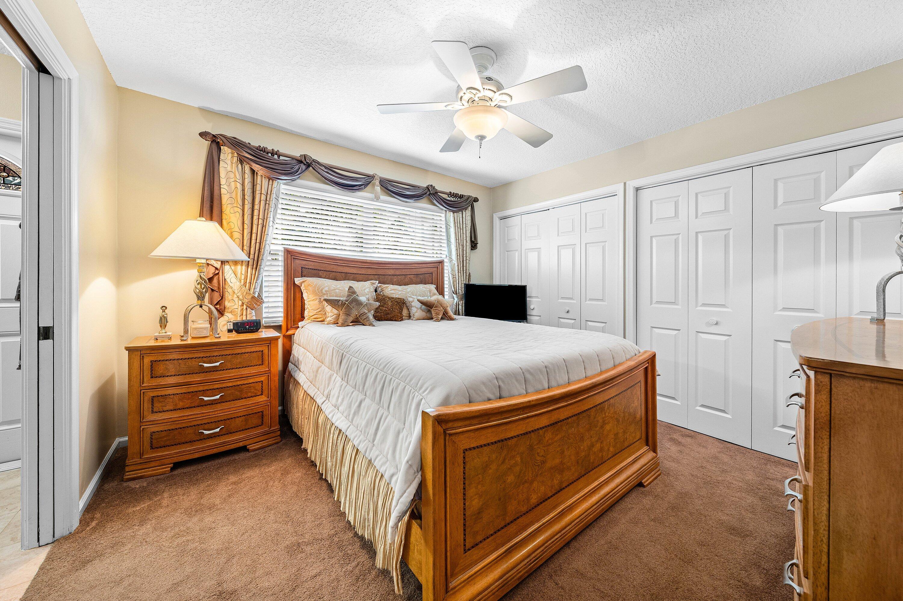 1548 Southwest 5th Avenue Boca Raton, FL 33432 - Photo 39 of 64 a bedroom with a bed and a chandelier