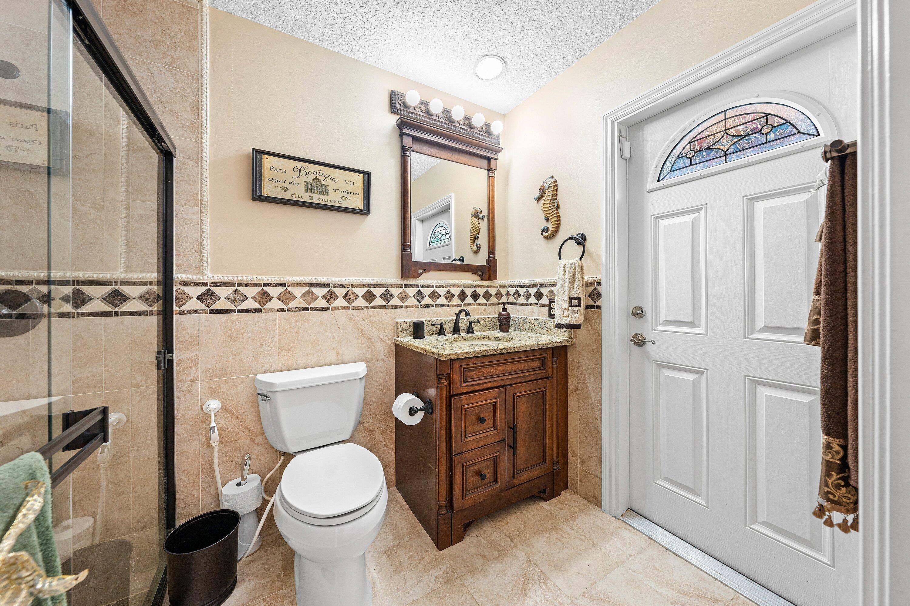 1548 Southwest 5th Avenue Boca Raton, FL 33432 - Photo 40 of 64 a bathroom with a toilet a sink and a mirror