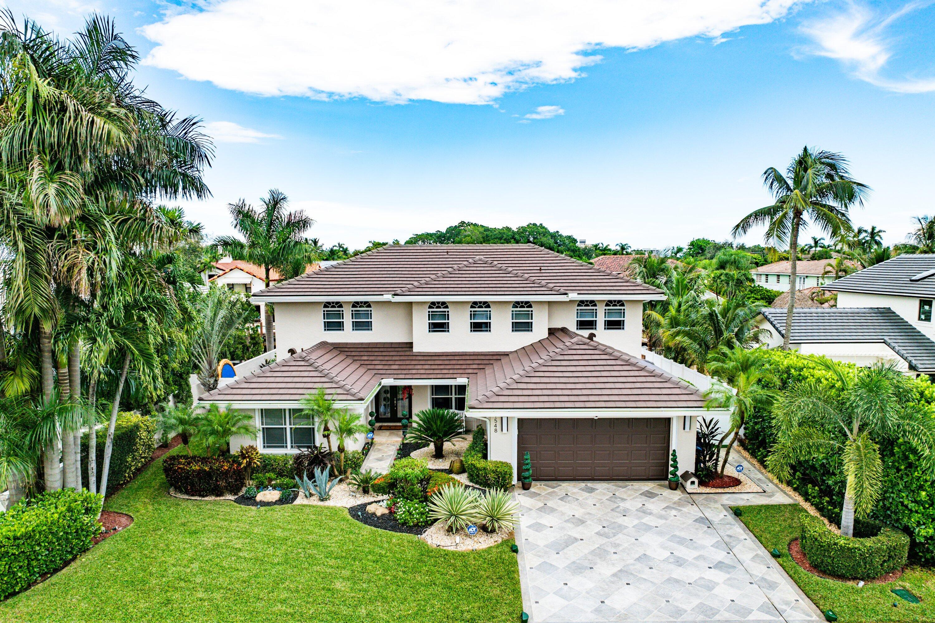 1548 Southwest 5th Avenue Boca Raton, FL 33432 - Photo 4 of 64 a front view of a house with a garden