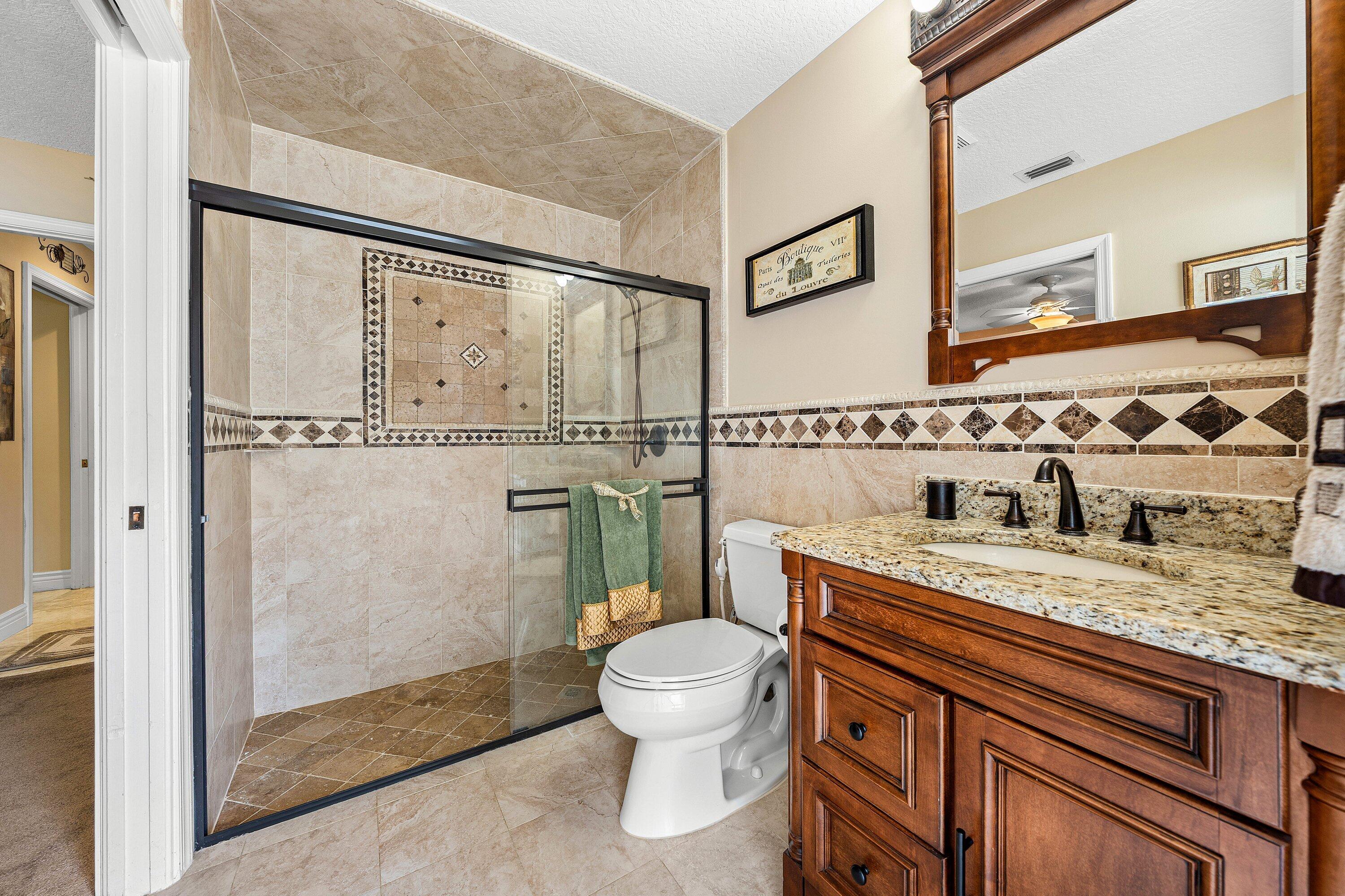 1548 Southwest 5th Avenue Boca Raton, FL 33432 - Photo 41 of 64 a bathroom with a granite countertop sink toilet and shower