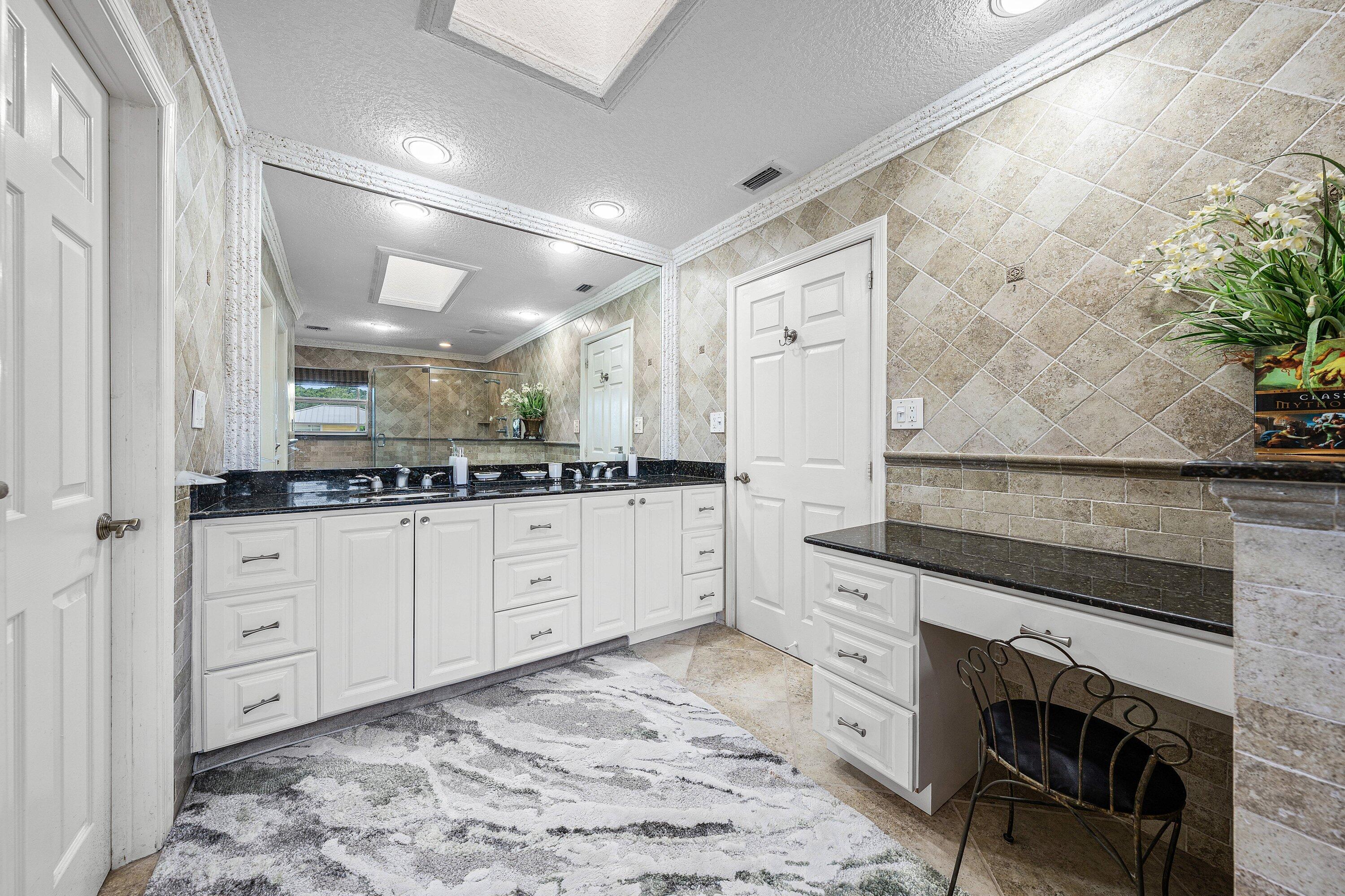 1548 Southwest 5th Avenue Boca Raton, FL 33432 - Photo 50 of 64 a spacious bathroom with a granite countertop sink and a mirror