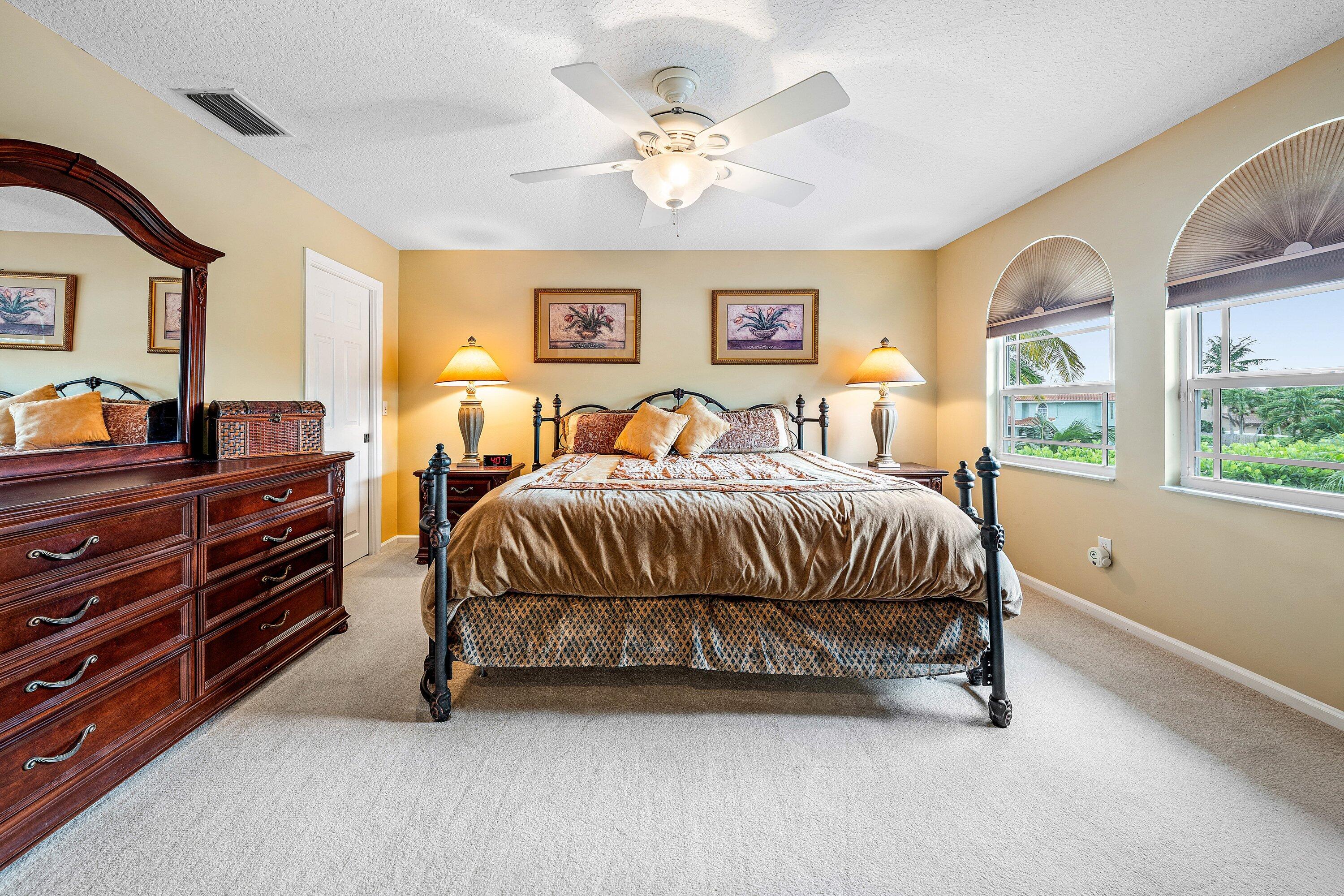 1548 Southwest 5th Avenue Boca Raton, FL 33432 - Photo 54 of 64 a bedroom with a bed and a chandelier
