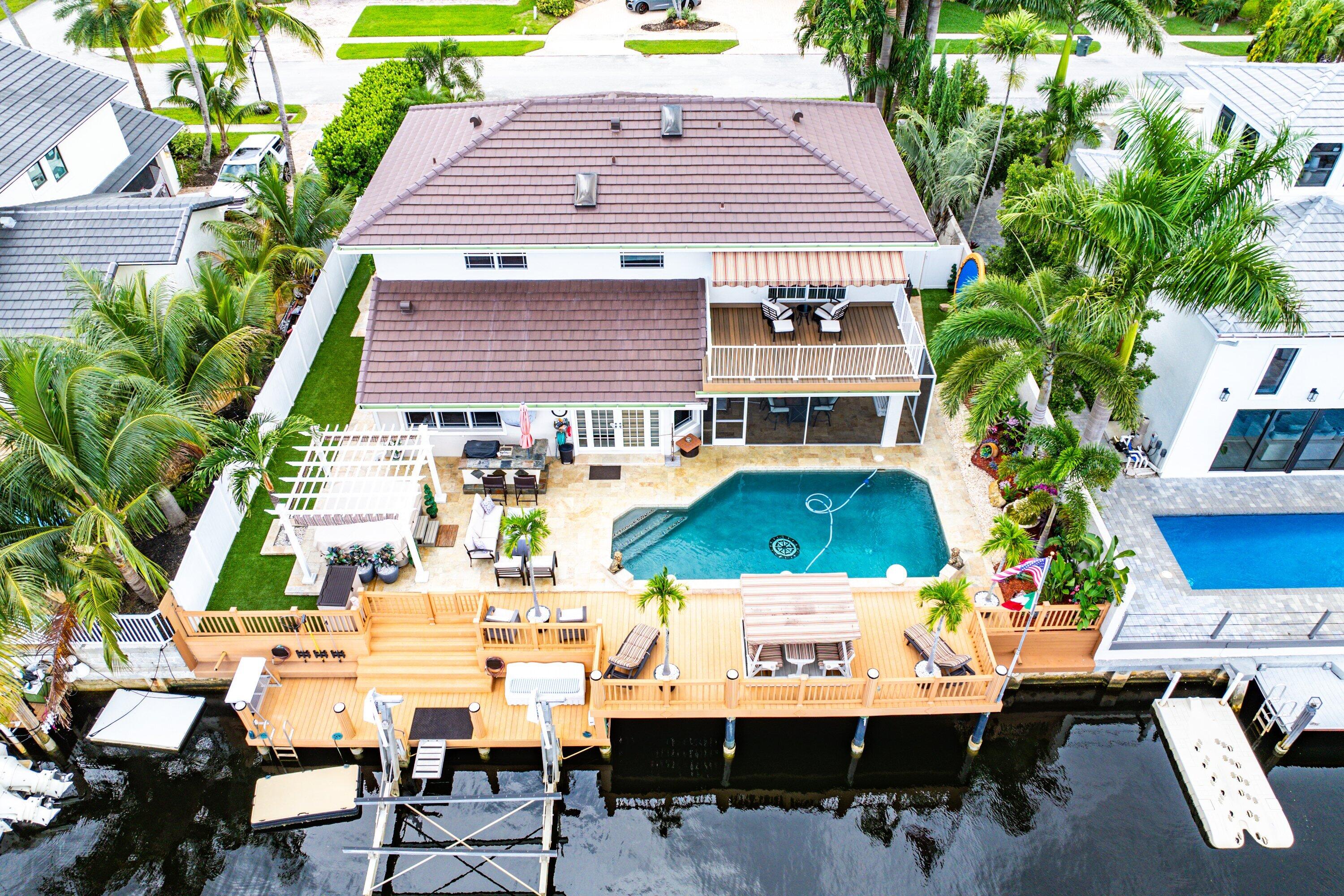 1548 Southwest 5th Avenue Boca Raton, FL 33432 - Photo 58 of 64 a view of a patio with table and chairs and potted plants