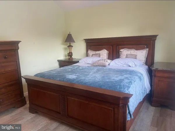 a bedroom with a bed and a night stand